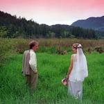 Bride & Groom Walk In The Grass.