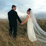 Bride & Groom Walking Up Grassy Hill