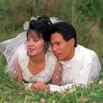 Bride & Groom Relaxing On The Grass.